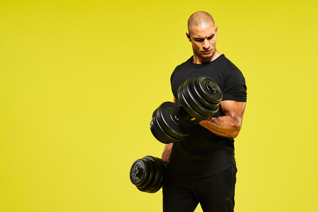 En man som tränar biceps med två svarta hantlar